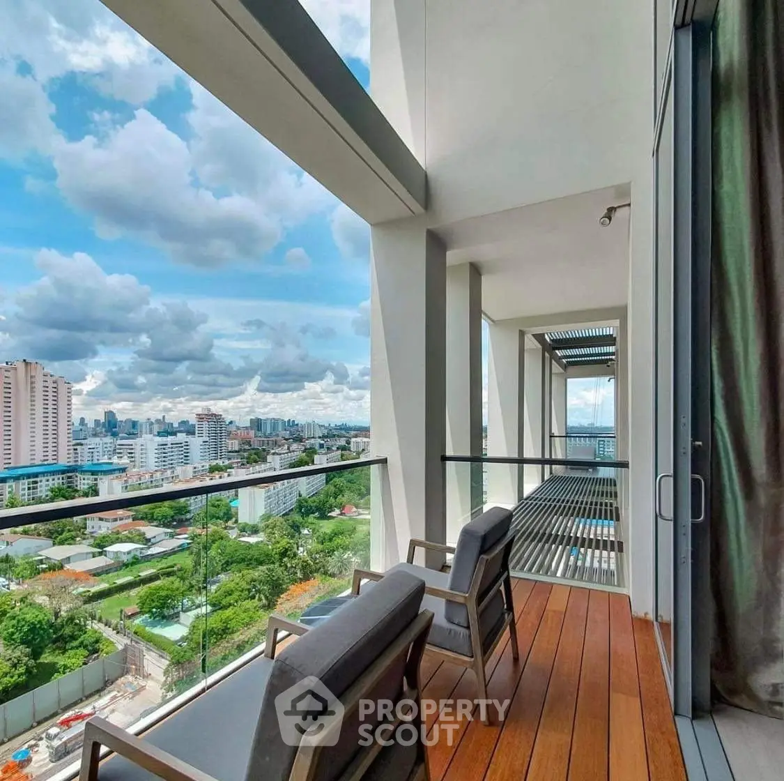Luxurious balcony with stunning city view and modern seating, perfect for relaxation and enjoying the skyline.