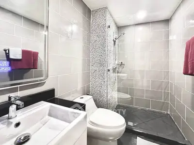 Modern bathroom with sleek tiles and glass shower enclosure