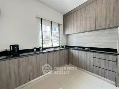 Modern kitchen with sleek cabinetry and gas stove in a stylish home.