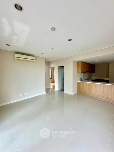 Spacious open-plan living room with modern kitchen and air conditioning
