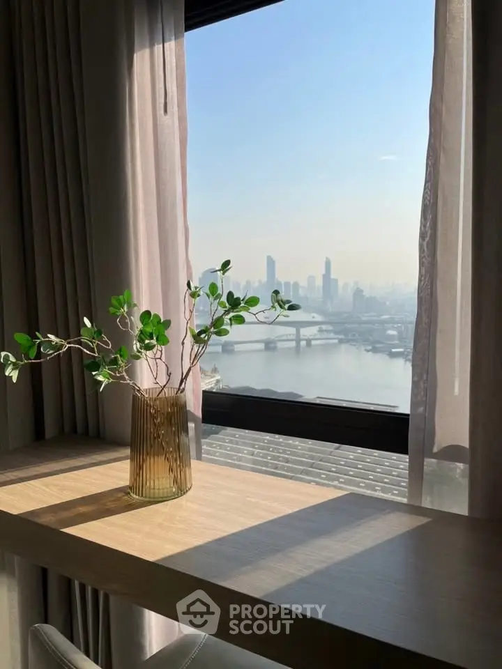 Stunning cityscape view from a modern apartment window with elegant decor and natural light.