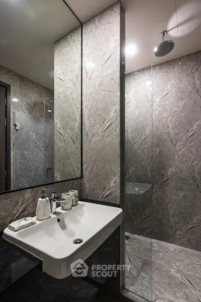 Luxurious modern bathroom with sleek marble walls and contemporary fixtures.