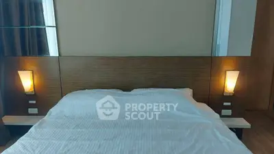 Cozy bedroom with modern lighting and wooden headboard