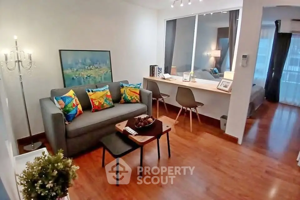 Modern living room with vibrant decor and cozy seating area in a stylish apartment.