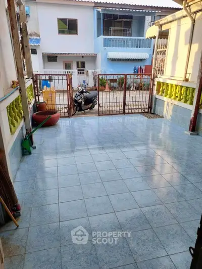 Spacious tiled patio with gated entrance in residential area