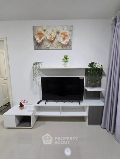 Modern living room with sleek TV stand and floral wall art, perfect for cozy family gatherings.