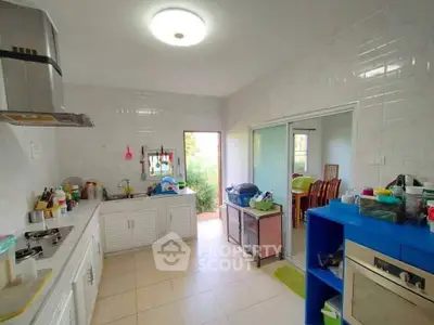 Spacious kitchen with modern appliances and open layout, perfect for culinary enthusiasts.