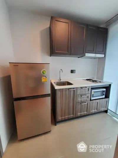 Modern compact kitchen with sleek cabinets and stainless steel appliances