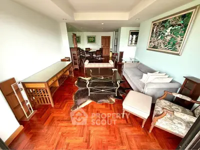 Spacious living room with elegant furniture and hardwood flooring