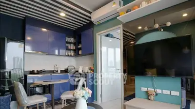 Modern living room with stylish kitchen and sleek decor in a contemporary apartment.
