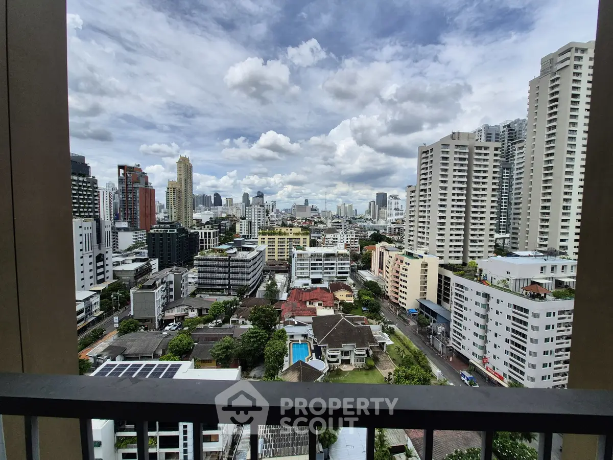 Stunning cityscape view from a high-rise balcony with modern urban skyline.