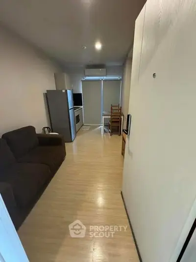 Cozy studio apartment with modern kitchen and comfortable living area, perfect for urban living.