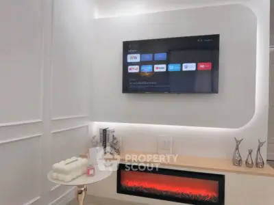 Modern living room with wall-mounted TV and electric fireplace