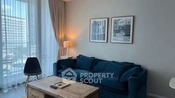 Stylish living room with cozy blue sofa and modern decor, perfect for relaxation.