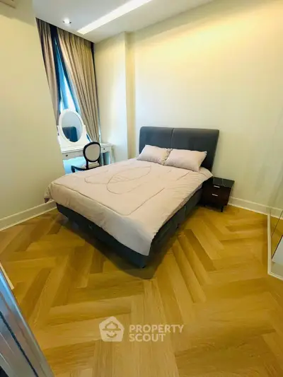 Cozy bedroom with stylish parquet flooring and elegant decor