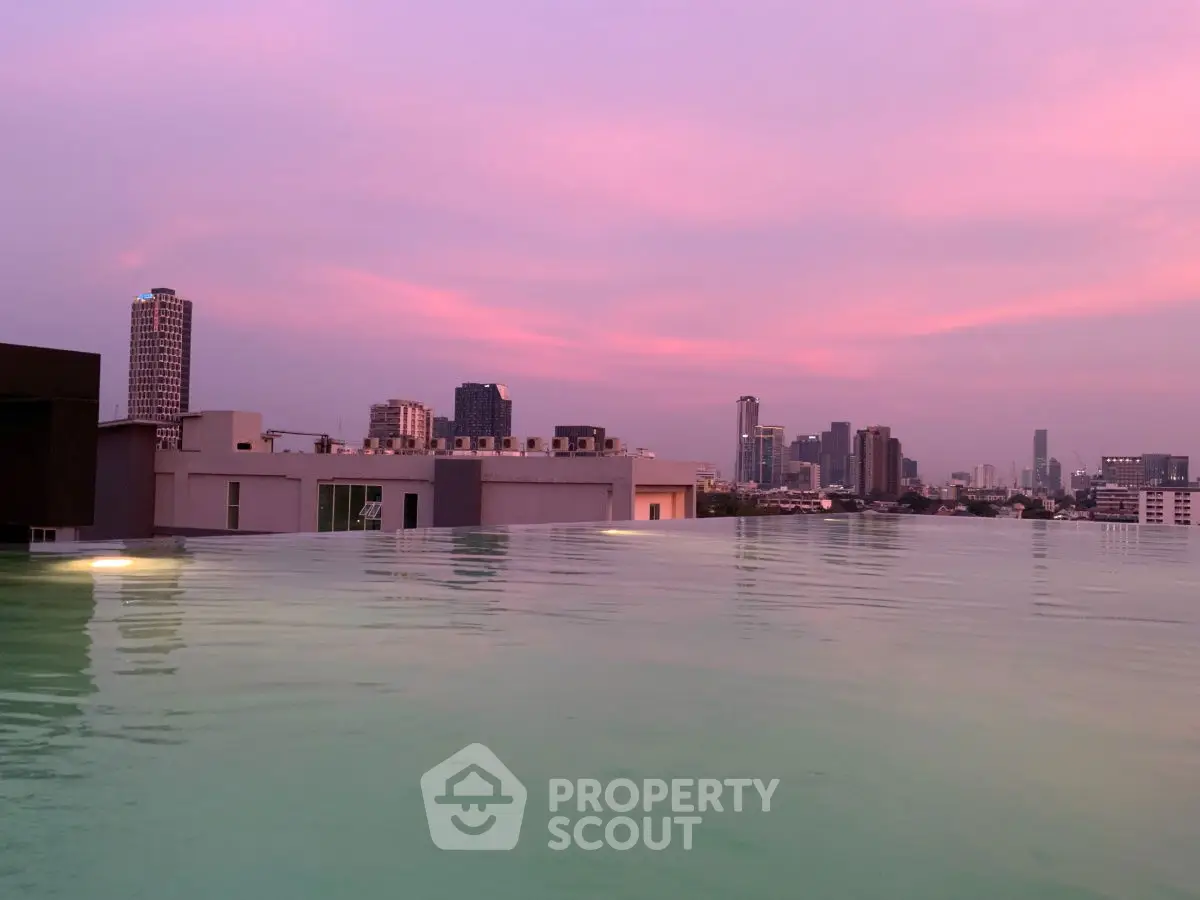 Stunning rooftop pool with panoramic city skyline at sunset