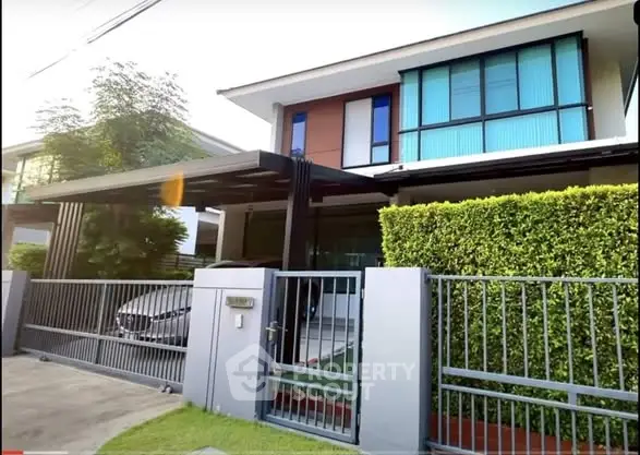 Modern two-story house with sleek design and gated entrance