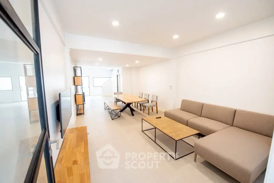Spacious modern living room with stylish furniture and ample natural light.