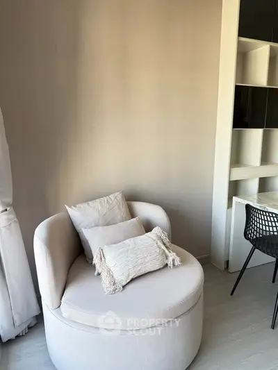 Cozy modern living room corner with stylish round chair and elegant shelving unit.