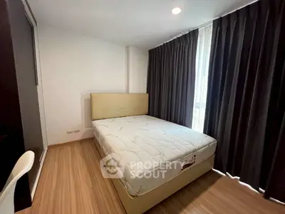 Cozy bedroom with natural light and modern furnishings, perfect for restful nights.