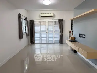 Spacious living room with modern design and ample natural light.