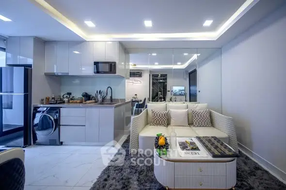 Modern open-layout living room with sleek kitchen and stylish decor