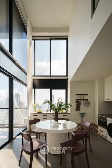Stunning modern dining area with floor-to-ceiling windows and city view