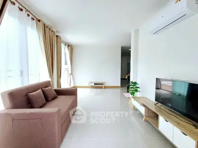 Spacious modern living room with large windows and stylish furniture