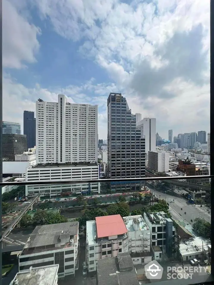 Stunning cityscape view from high-rise balcony showcasing urban skyline and vibrant city life.