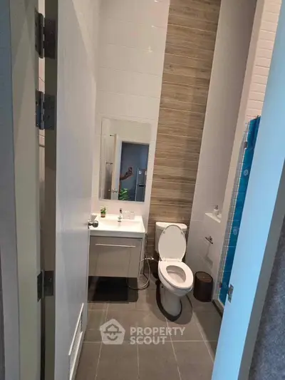 Modern compact bathroom with sleek fixtures and stylish tile design.