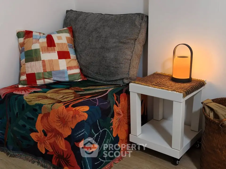 Cozy corner with vibrant cushions and ambient lighting, perfect for relaxation.