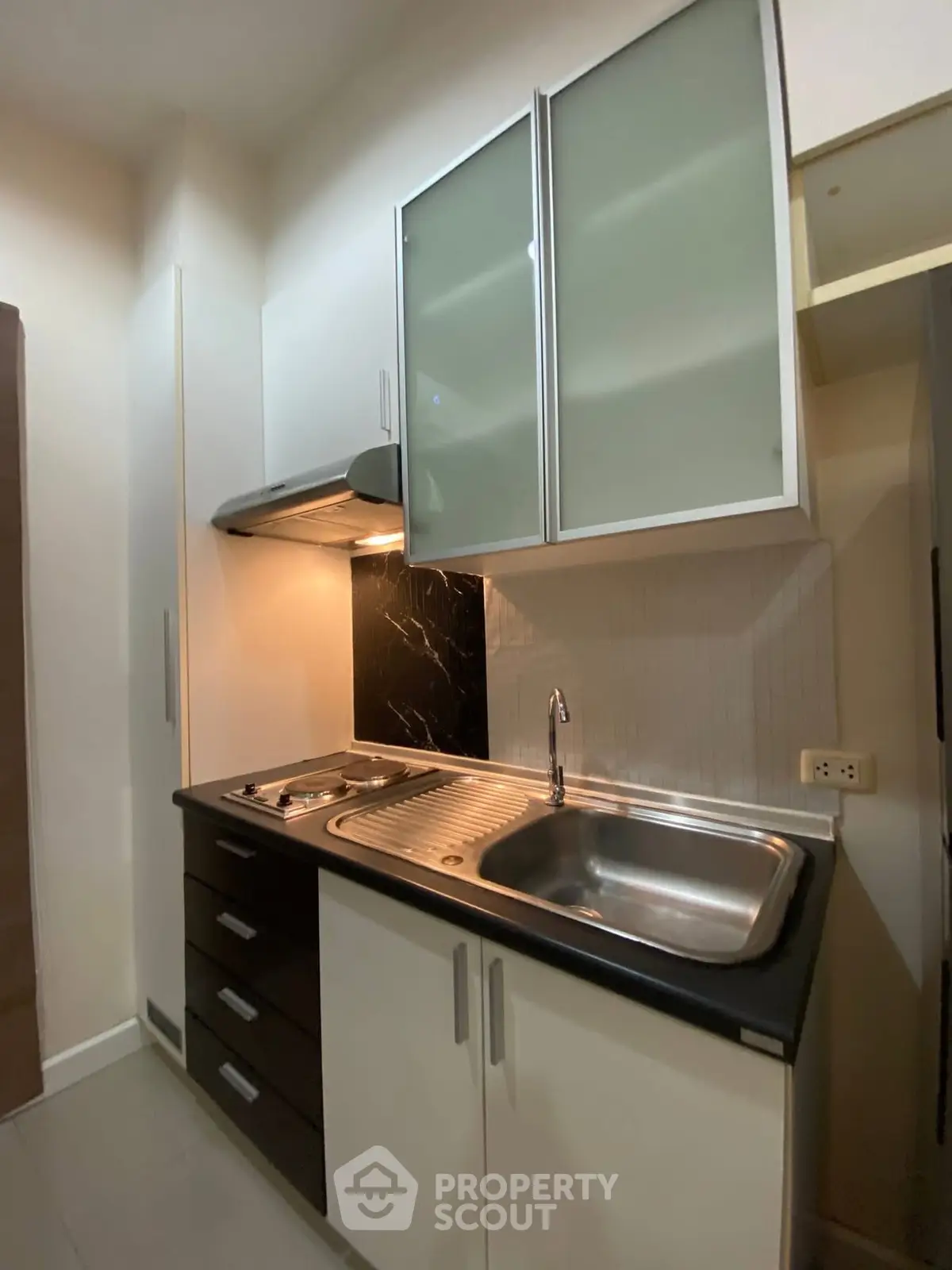 Modern compact kitchen with sleek cabinets and stainless steel sink