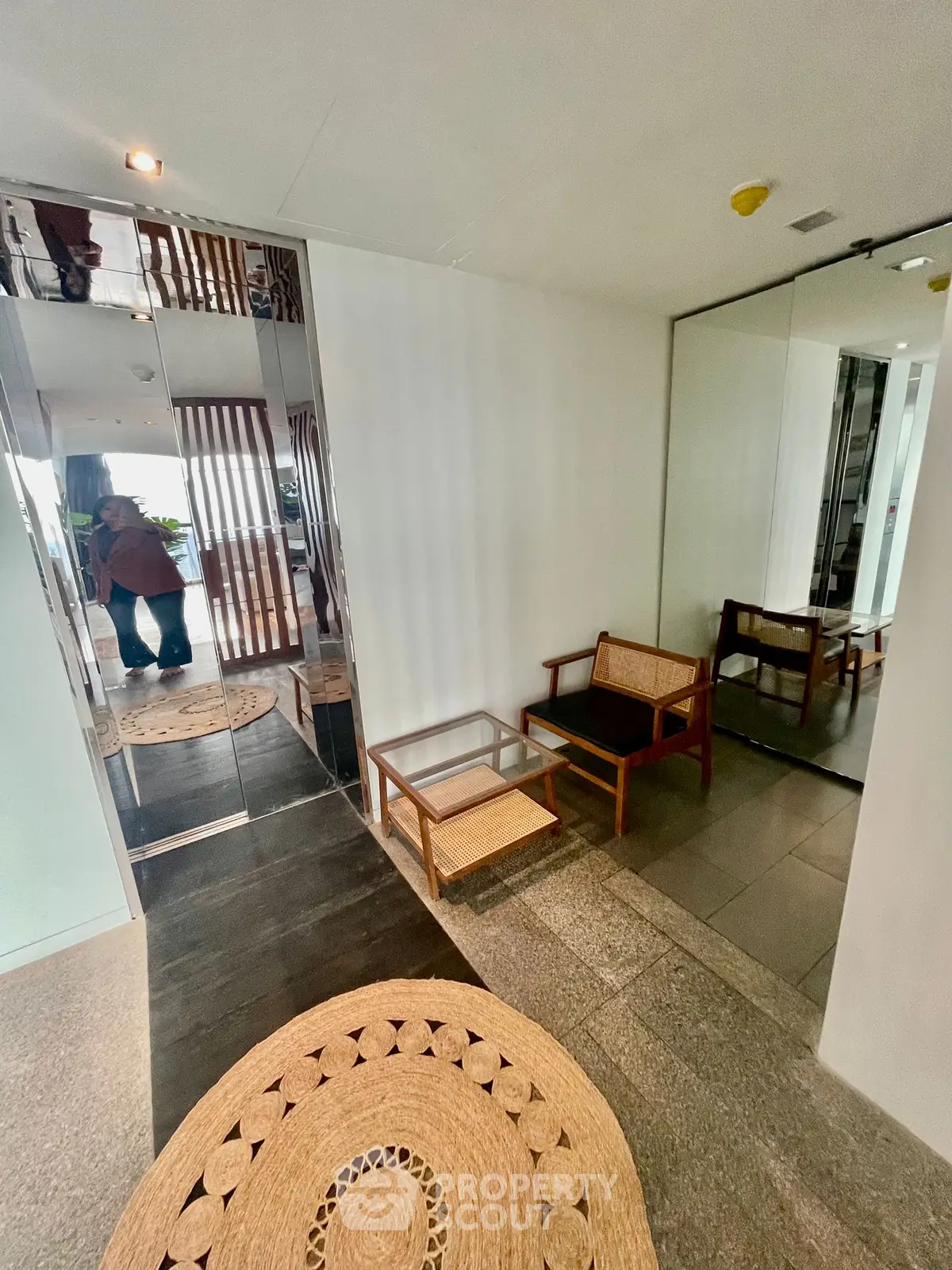 Elegant modern elevator lobby with stylish seating and mirrors