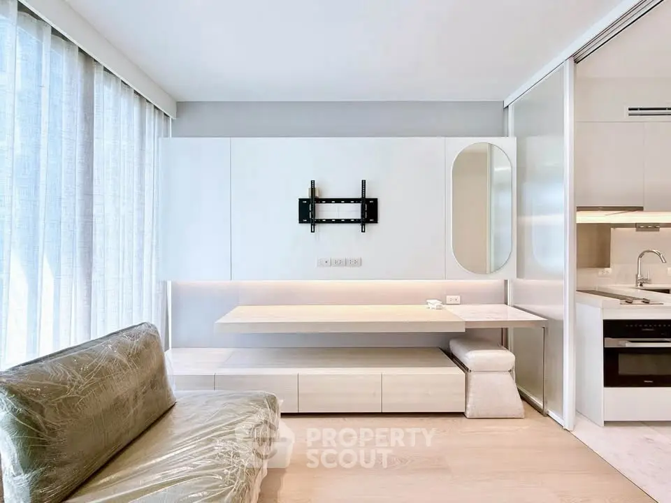 Modern living room with sleek furniture and built-in kitchen appliances