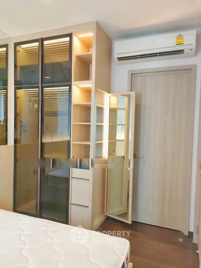 Modern bedroom with built-in wardrobe and air conditioning unit