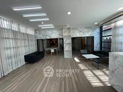 Spacious modern living room with marble accents and elegant furnishings