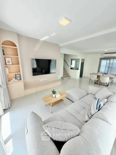 Spacious modern living room with sleek design and cozy seating area.
