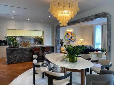 Luxurious open-plan living and dining area with elegant decor and modern kitchen