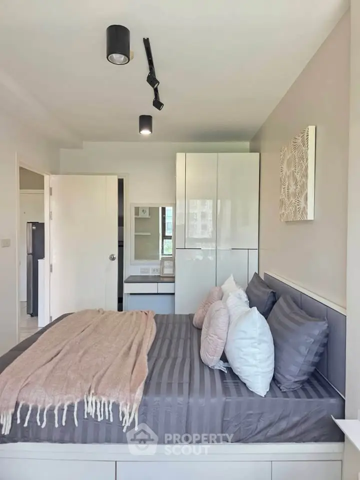 Modern bedroom with stylish decor and ample natural light