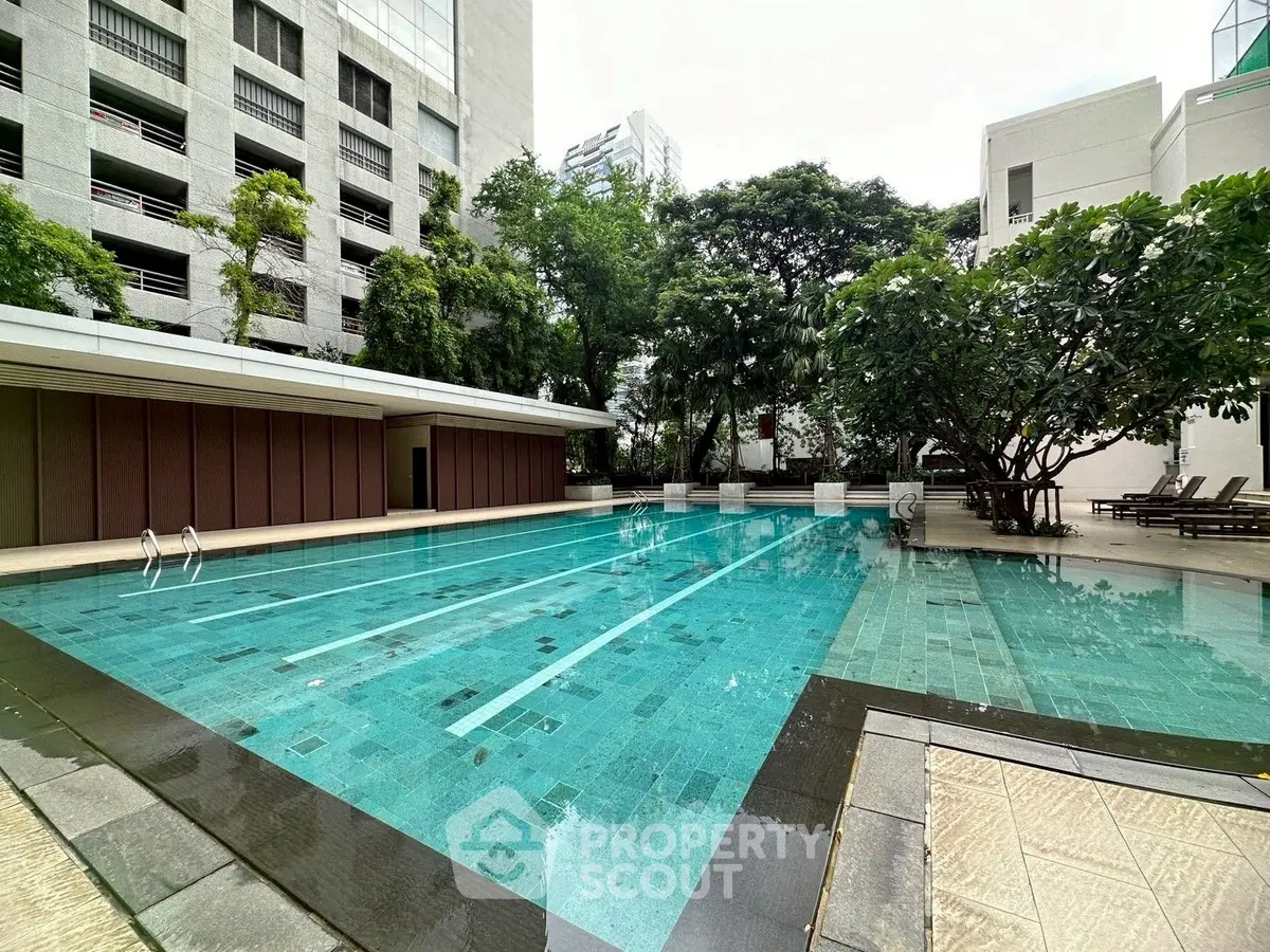 Luxurious outdoor pool area with modern design and lush greenery