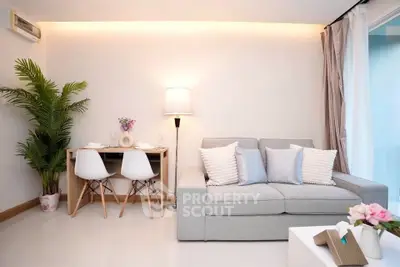 Modern living room with cozy sofa and dining area, perfect for relaxation and entertaining.