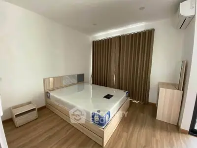 Spacious bedroom with modern furnishings and natural light