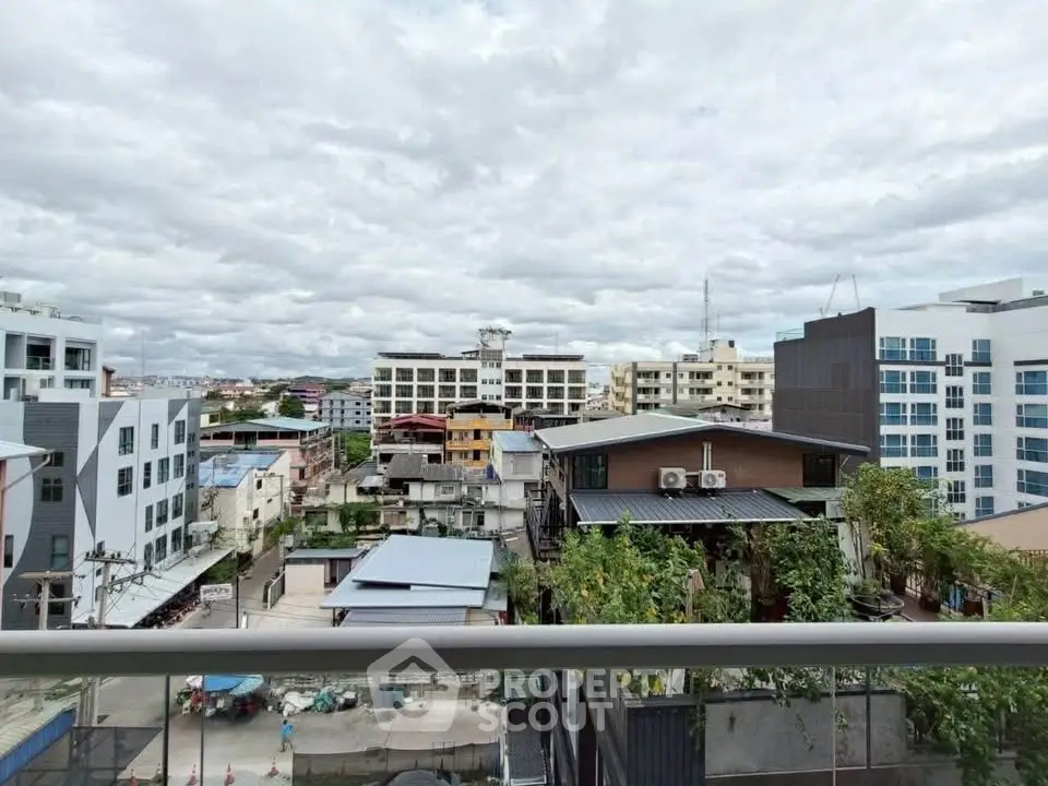 Stunning urban view from a high-rise balcony showcasing cityscape and skyline.