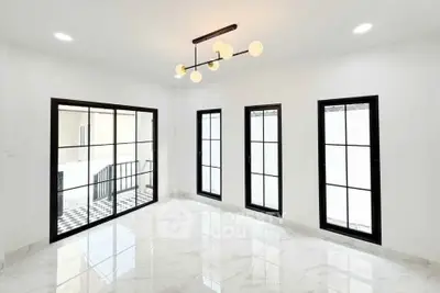 Spacious modern living room with elegant lighting and large windows