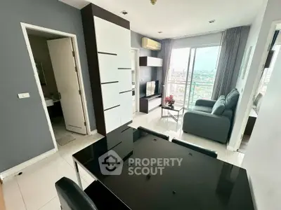 Modern living room with city view, sleek furniture, and stylish decor in a high-rise apartment.