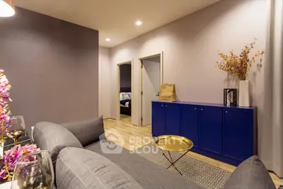 Stylish living room with modern decor and vibrant blue cabinet