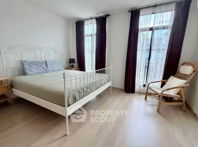 Spacious bedroom with elegant decor and natural light