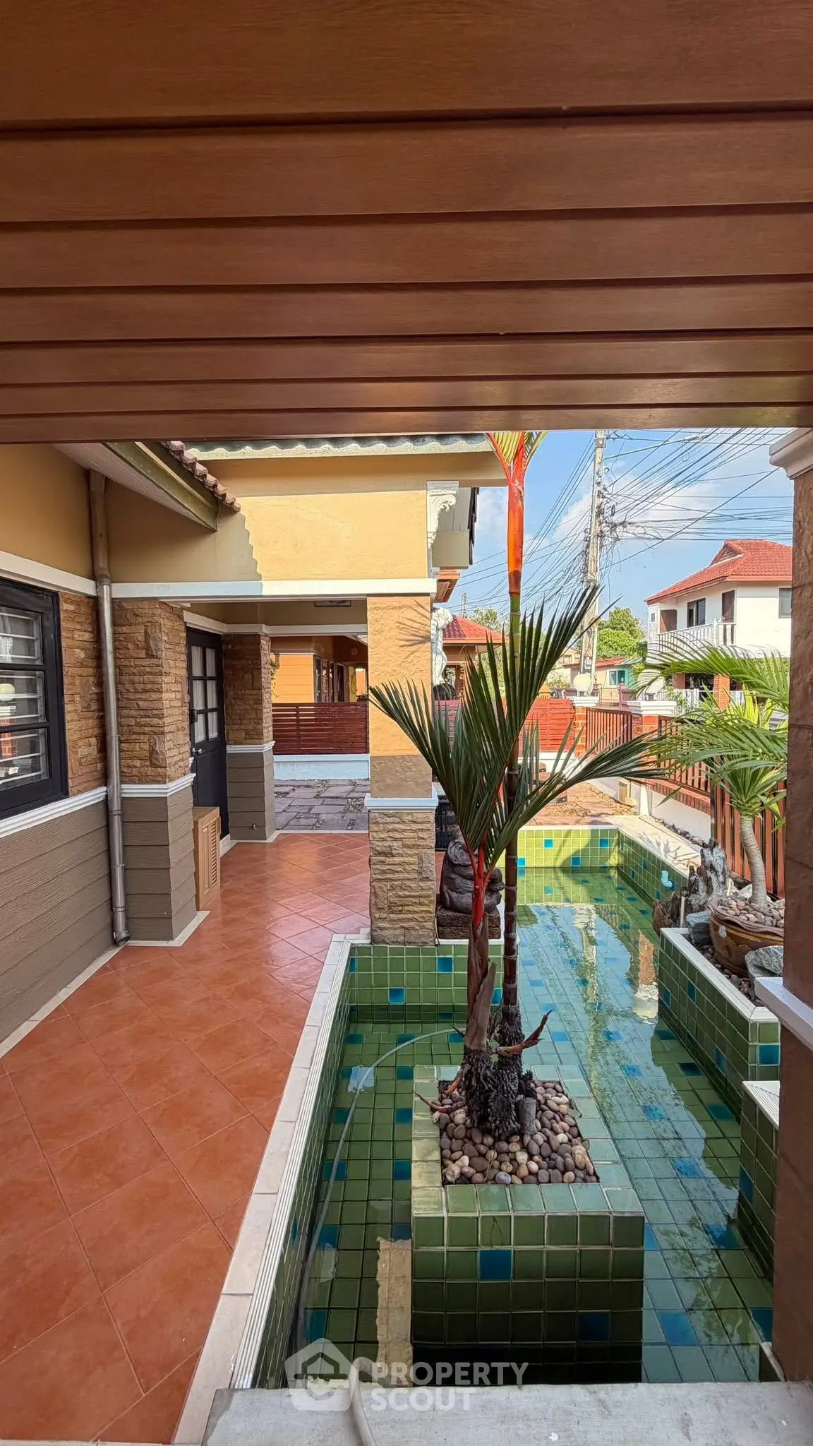 Charming residential property with a stylish outdoor pool and lush greenery, perfect for relaxation and entertainment.