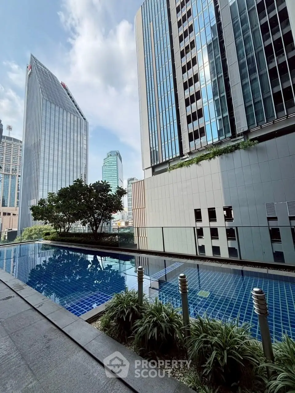 Luxurious urban poolside with stunning skyscraper views in a modern cityscape.