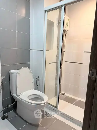 Modern bathroom with sleek shower and contemporary toilet design.